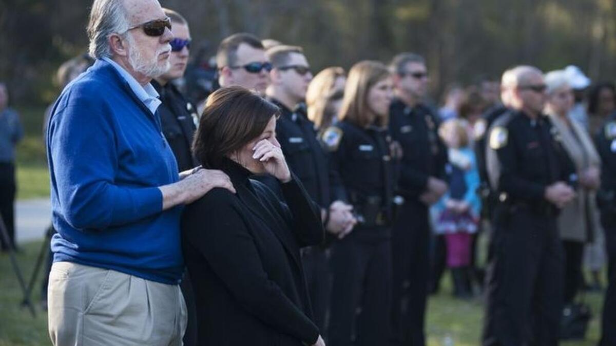 Chuck and Colleen Hinton attend a vigil for slain Greenville Officer Allen Jacobs earlier this week.