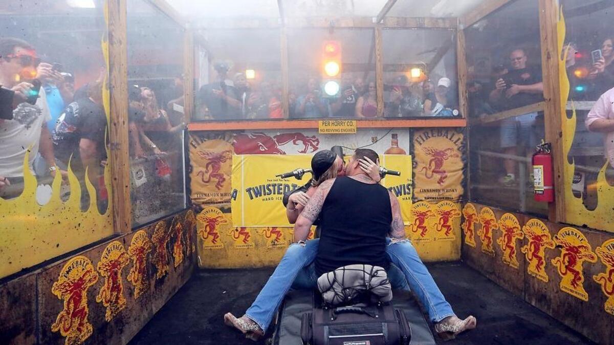 Jonathan and Martha King are spending some time in the burn out pit while on their honeymoon at Suck Bang Blow on Thursday, May 19, 2016. The couple are from Staunton, Va., and were married a week ago. Jonathan said their honeymoon choices included Hawaii, but Martha chose Murrells Inlet for the annual Myrtle Beach Bike Week Spring Rally. The rally continues along the Grand Strand through the weekend. Events span the coast from Little River to Georgetown.