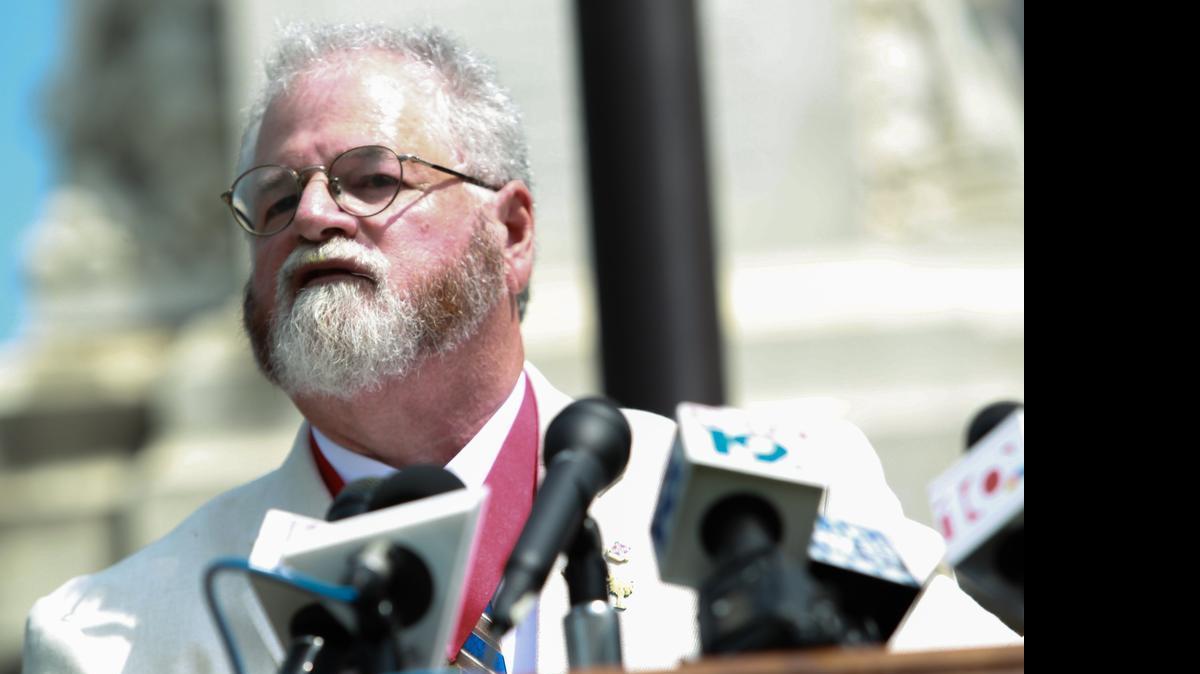 
Commander of the Son's of Confederate Veterans Commander Leland Summers addresses a crowd of media during a press conference on the South Carolina State House grounds. 
