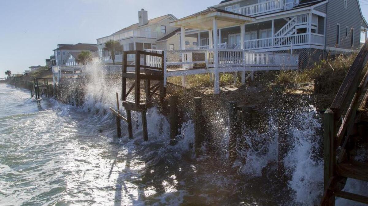 Waves crash against the sea wall during a regular high tide at Garden City Point on Thursday. Extreme “King Tides” expected this weekend may do further damage to area beaches.