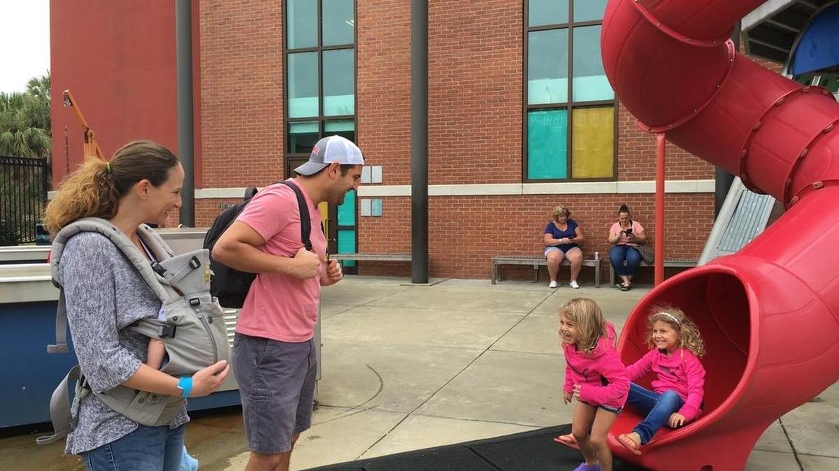 Whitney and Tom LaMaida watch daughters Delaney (left) and Kendall play at EdVenture.