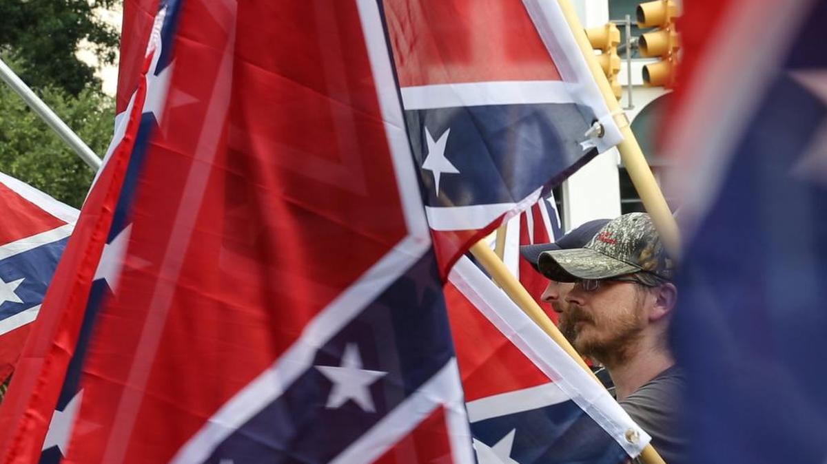 FILE PHOTO. On the second anniversary of the removal of the Confederate battle flag from the South Carolina State House grounds, members of the S.C. Secessionist Party held a rally to raise the flag in honor of Confederate soldiers killed in battle.