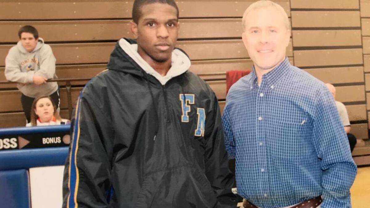 Jayvion “Jay” Sullivan, left, and Fort Mill High School wrestling coach Chris Brock in 2011. Sullivan, a 2011 graduate of the school and Army specialist, died in Iraq Monday.