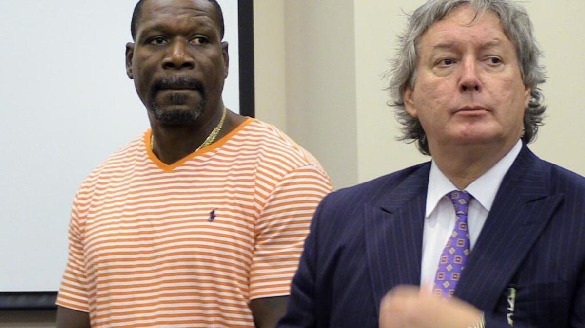 David Morgan, left, rejects a plea deal Thursday at a hearing at Moss Justice Center as his defense attorney Michael Brown listens.