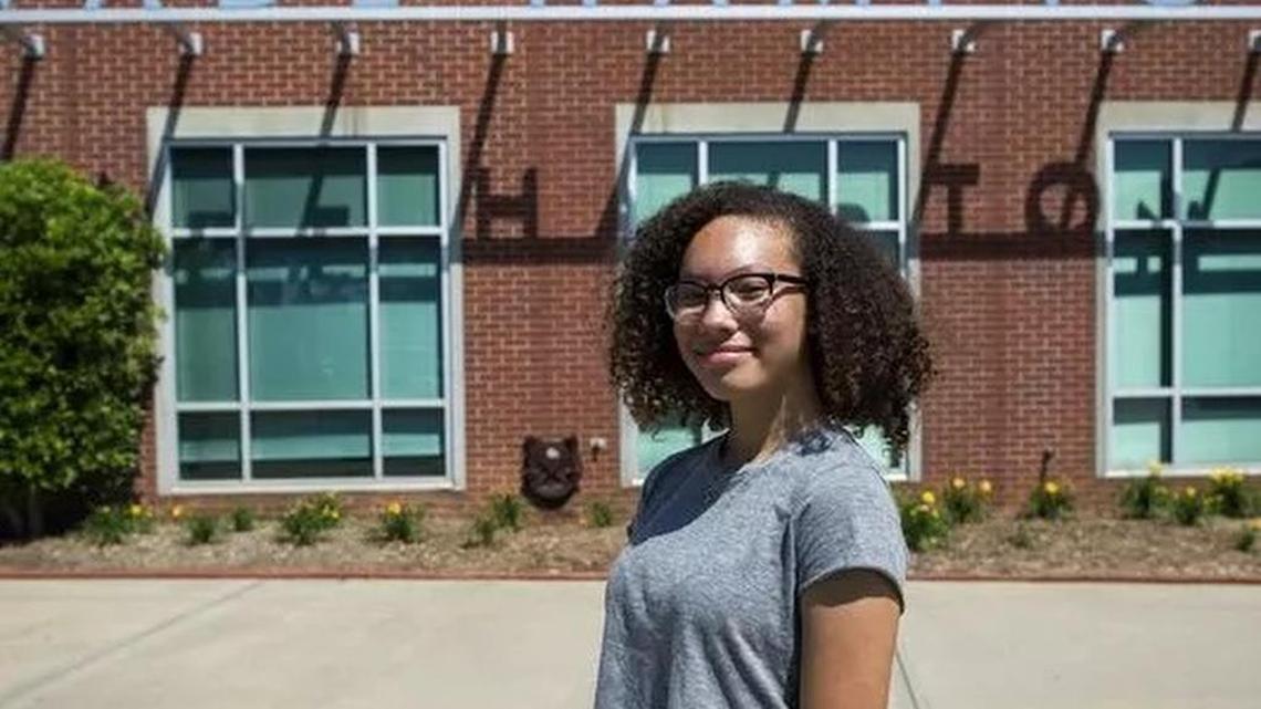Asha Marie stands in front of the Wade Hampton High School sign Tuesday. Marie started a petition to officially change the school’s name after finding out it was named after a Confederate general and slaveholder.