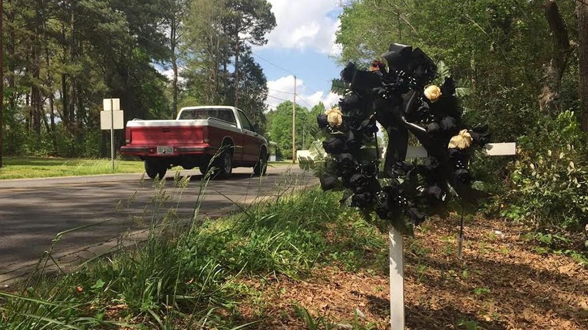 A cross and wreath mark the spot on Lincoln Road in York where 77-year-old Carlos Madriaga was fatally struck by a school bus two weeks ago. Prosecutors announced Thursday they will not file charges against the driver.