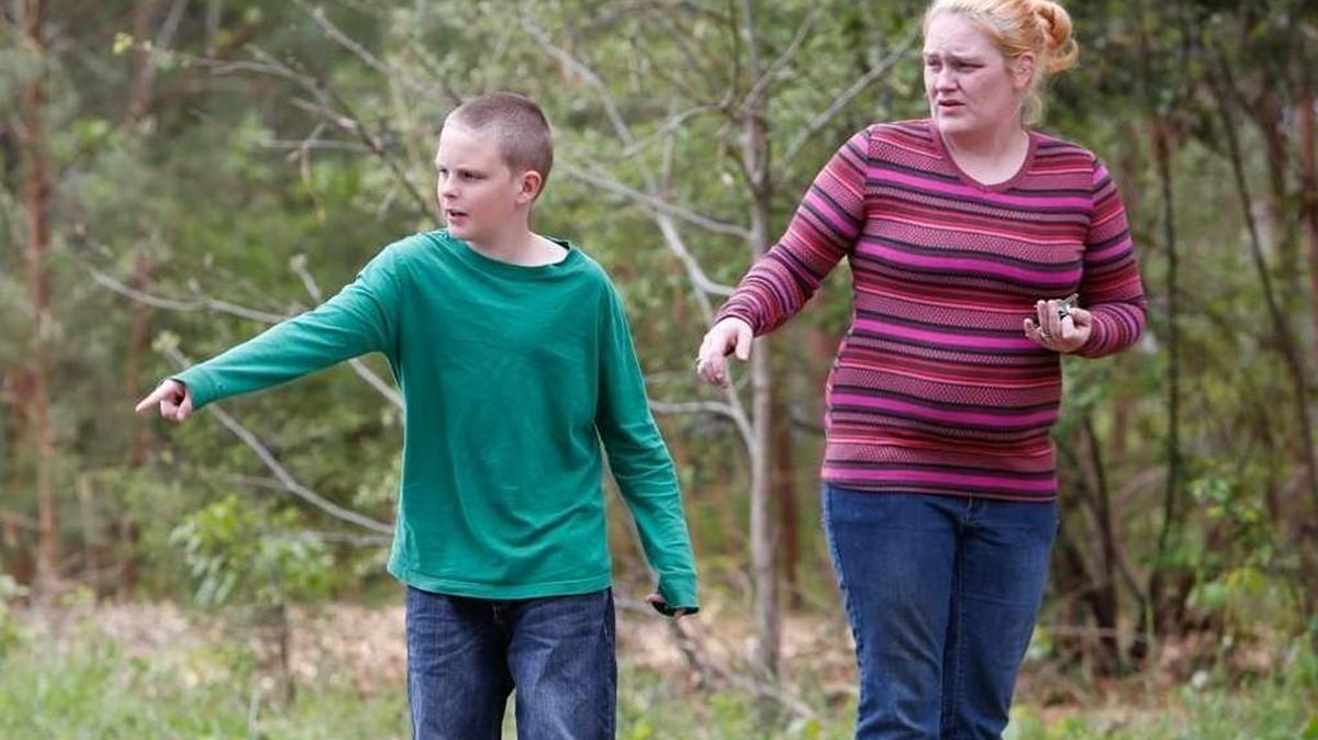 Michael Huskey, 10, points out to his mom Terrie Ruff the spot where he claimed a man tried to abduct him and his cousin as they walked to school. Deputies on Wednesday said the story was made up so the boys could skip school.