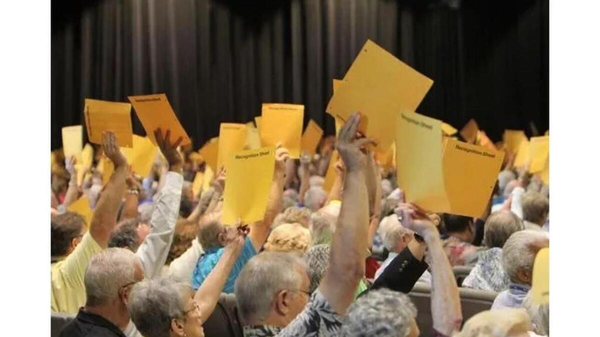 Members of the South Carolina Conference of The United Methodist Church wave cards to vote Wednesday.