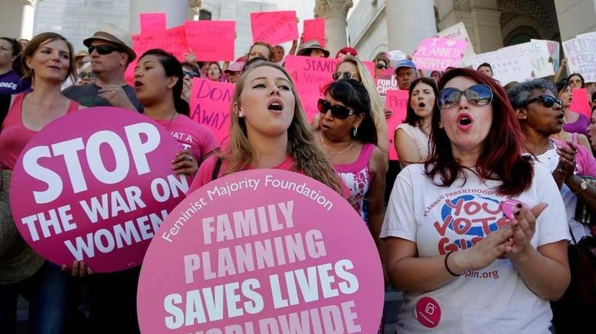 In this Sept. 9, 2015, file photo, Planned Parenthood supporters rally for women's access to reproductive health care on "National Pink Out Day'' at Los Angeles City Hall.