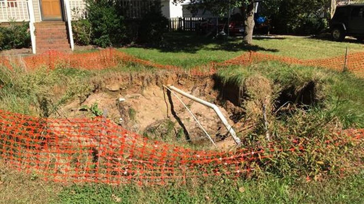 FILE PHOTO (Nov. 2014) A sinkhole in Easley’s Oak Creek subdivision shows the extent of damage a faulty drainage system has caused over the years.