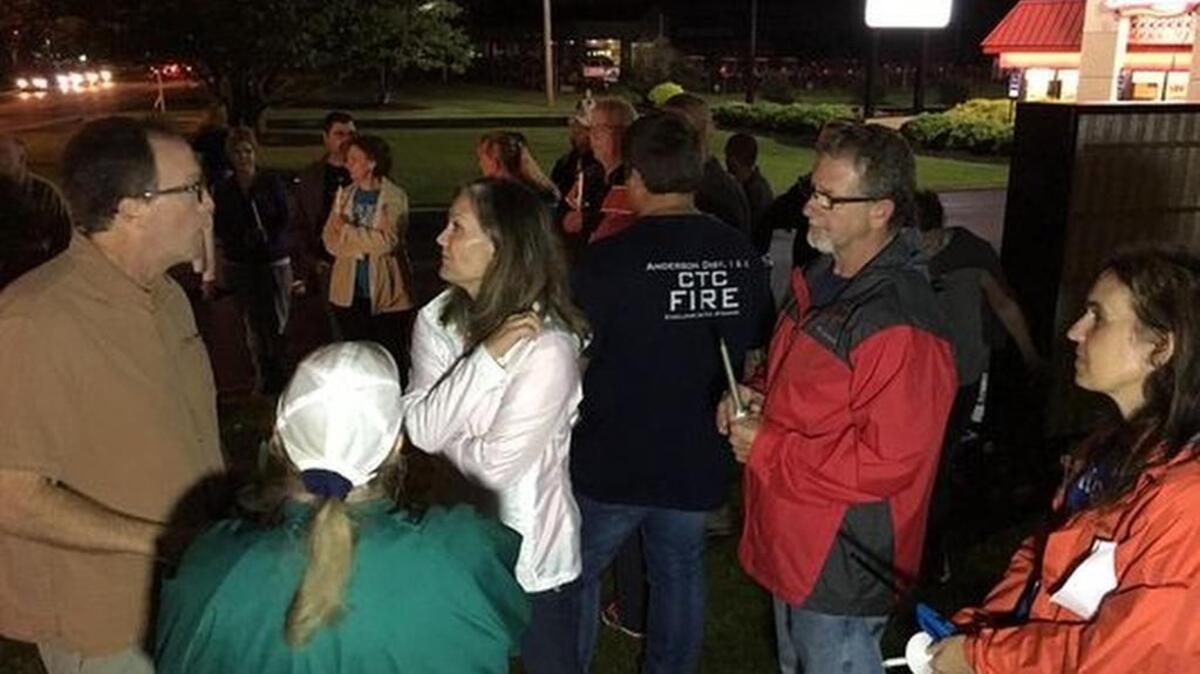 
Angie and Paul Hammond, parents of Zachary Hammond, are surrounded by supporters during a vigil to mark the 2-month anniversary of their son’s death. 
