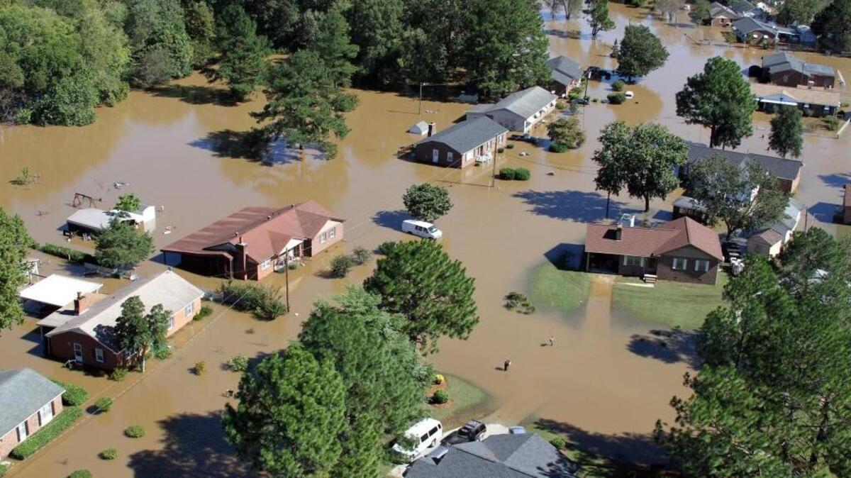 Flood waters surround several houses in Rocky Mount, N.C., near the Tar River Monday afternoon, Oct. 10, 2016. Heavy rains from Hurricane Matthew caused extensive flooding across eastern North Carolina last year.