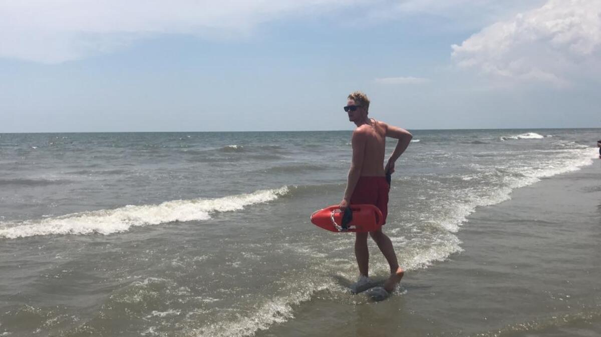 A lifegaurd with Hilton Head Shore Beach Services monitors the water after a shark was spotted Thursday afternoon.