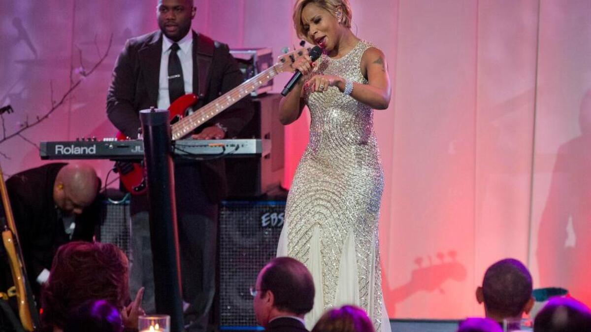 FILE - In this Feb. 11, 2014 file photo, singer Mary J. Blige performs on stage during the entertainment portion of the State Dinner for French President President Francois Hollande, center, seated with first lady Michelle Obama, left, and President Barack Obama, on the South Lawn of the White House in Washington. Whether belting out lyrics to Al Green’s "Let’s Stay Together," leading a mournful congregation through "Amazing Grace," or tweeting his Spotify music playlist that includes Stevie Wonder and Nina Simone, President Barack Obama is showing that he’s a pretty soulful guy. (AP Photo/Pablo Martinez Monsivais, File)