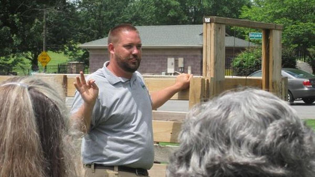 Wildlife specialist Chase Simmemon provides instruction on setting traps for wild hogs.