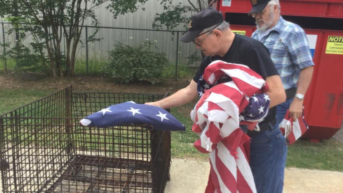 Vietnam veterans Lloyd Comer, left, and Ken Dennings, right, prepare torn, unserviceable American Flags Tuesday for burning on Flag Day Wednesday at a disposal service at Rock Hill VFW Post 2889.