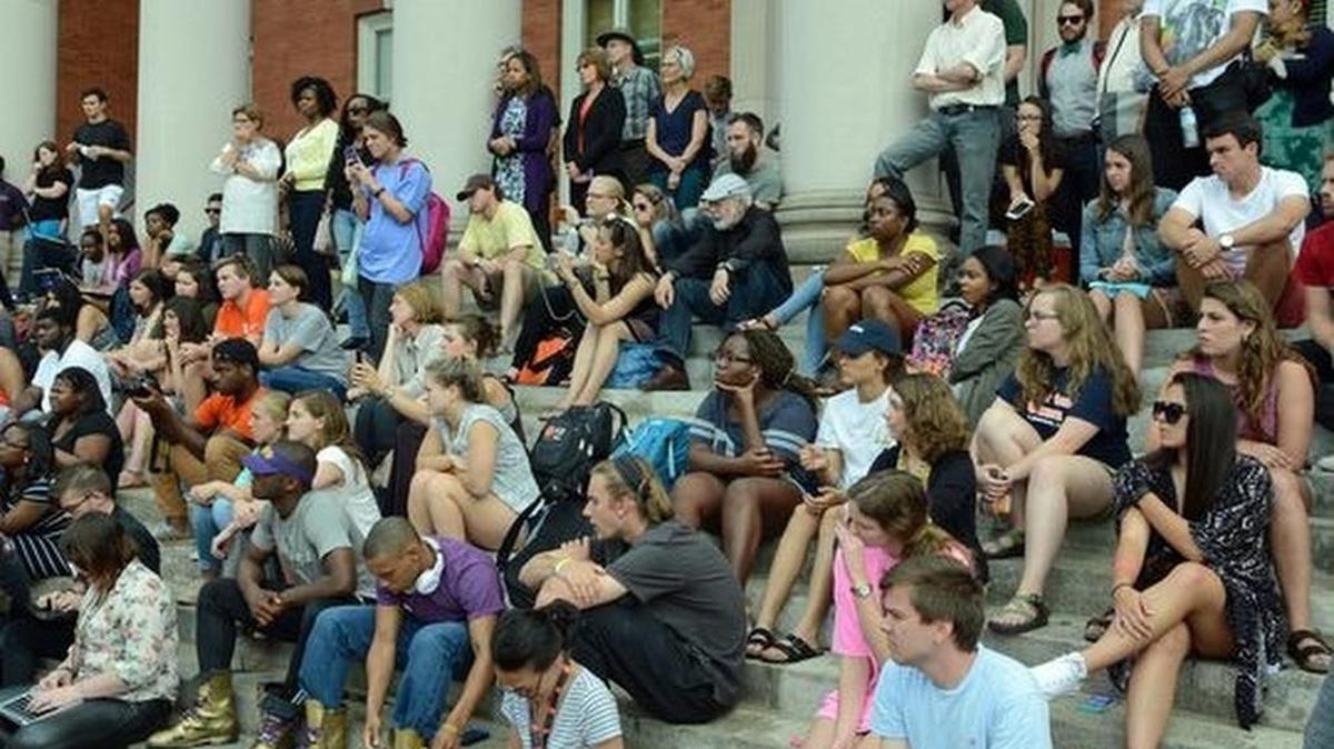 A large crowd covered the steps of Sikes Hall as student organizers announced they were suspending their sit in Thursday.