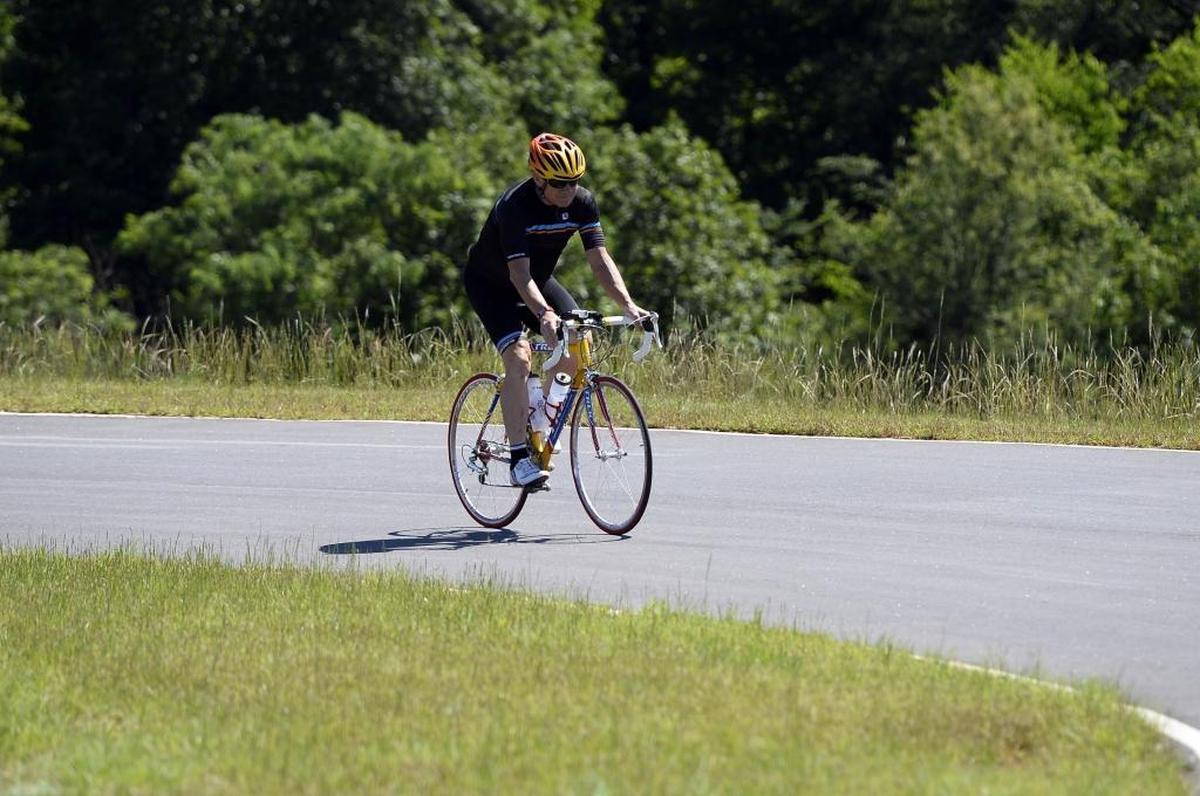 Paul Neal rides the Riverwalk criterium course in Rock Hill. On Monday, he makes good on a 50-year-old promise – repeating the cross-country bike trip he made as a teenager, and doing it in the same amount of time.