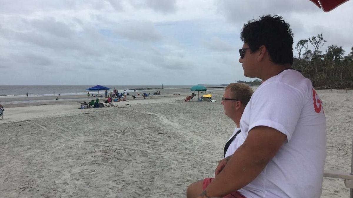 Hunting Island lifeguards Vince Dean, seated, and Ben McHone watch swimmers Thursday on the North Beach.