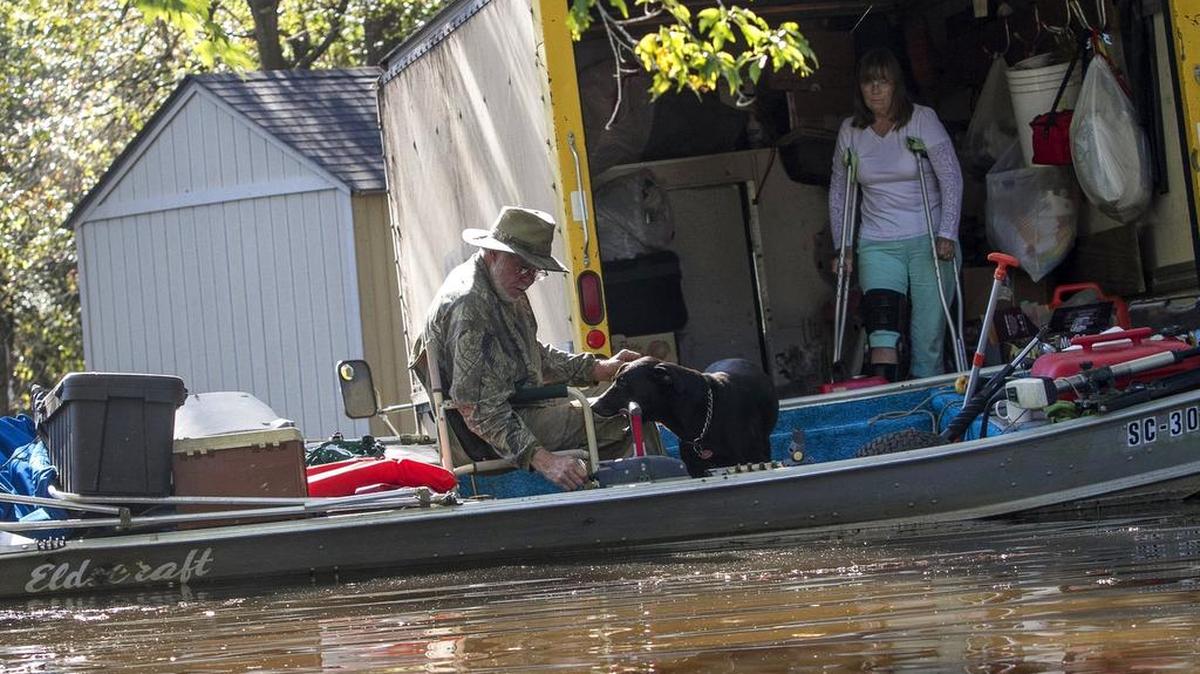 Richard and Rachael Ledbetter took shelter with their dogs in a flooded panel truck when Little Pee Dee river flooded unexpectedly on Tuesday. Unsure whether to leave the property, the Ledbetters say they had little warning of the rising waters and have lost all forms of transportation other than their boat. When all their neighbors evacuated on Tuesday, the Ledbetters were still considering staying the night in their truck. Tuesday.