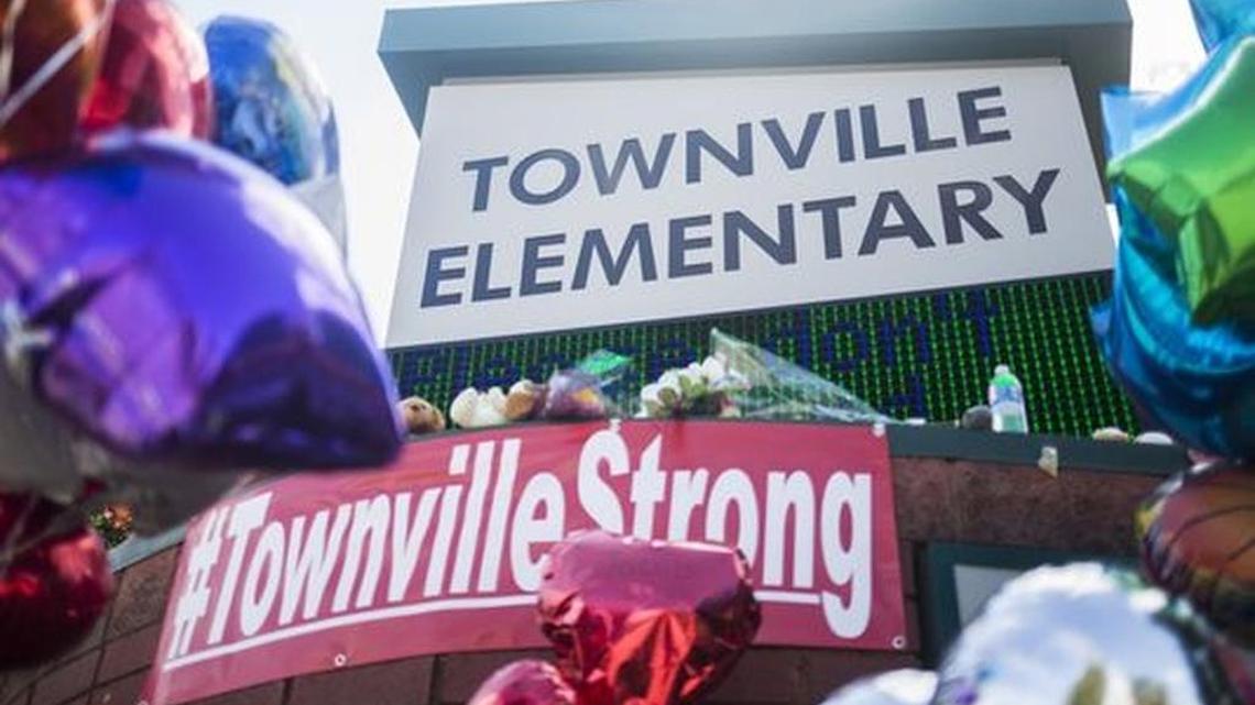 A memorial with supportive notes, stuffed animals, flowers, and balloons is set up outside Townville Elementary on Oct. 1 in Townville.