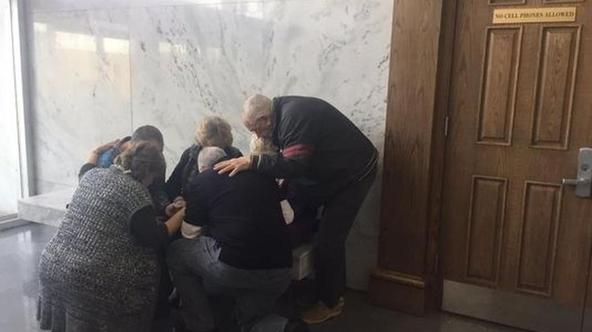 Todd Kohlhepp’s mother prays with family members of her son’s alleged victims outside of court Thursday morning.