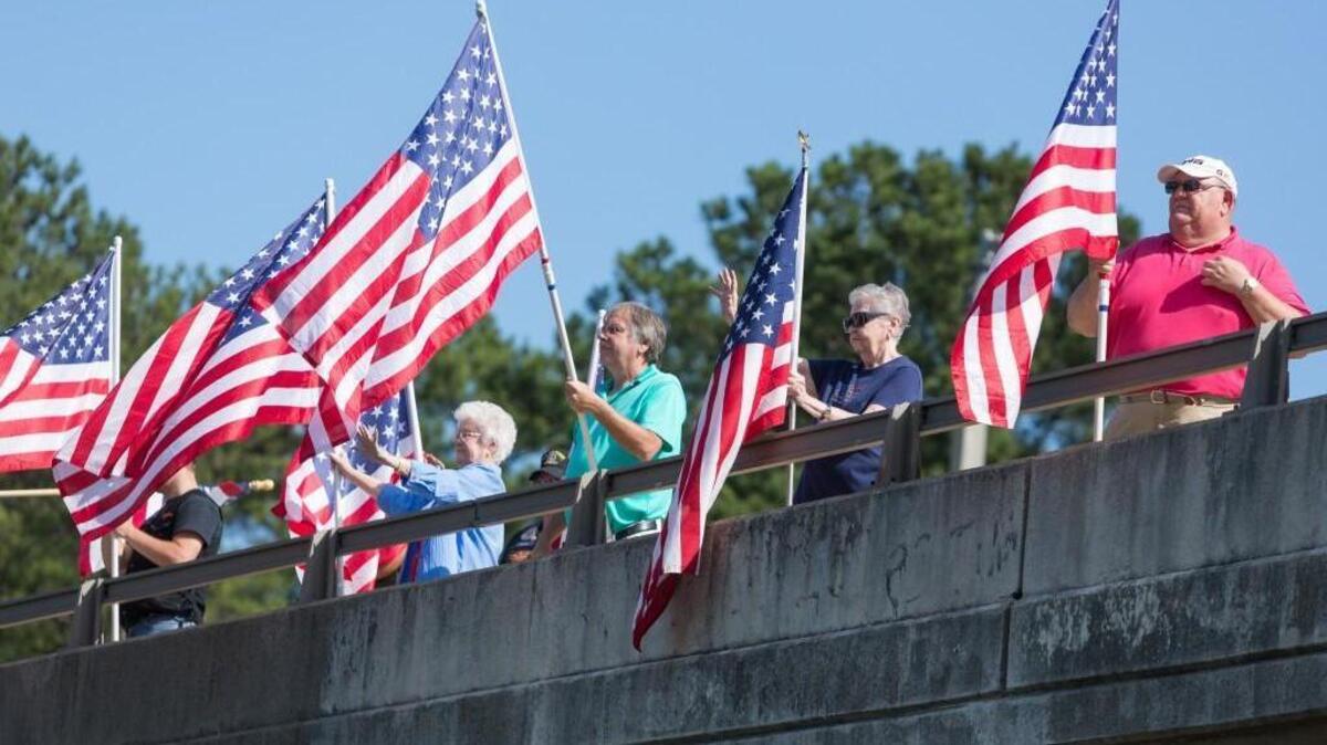 Community members stand with Betty Farrington (second from right) on the Leonard A. Farrington overpass in Fort Mill to celebrate Memorial Day.
