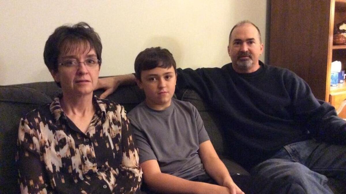 Stephen Martin, 13, sits between his father Lee Martin and mother Amy Martin. Stephen Martin’s parents say a student making threats against Forestbrook Middle School was posing as Stephen Martin, and that their son is innocent.