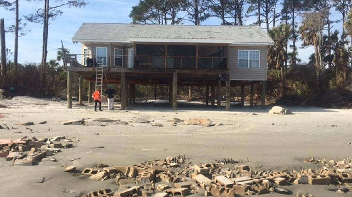 The cabin at 28 Cabin Road on Hunting Island stands exposed after the dunes were washed away.
