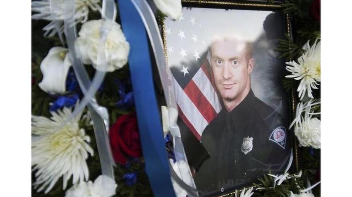 Greenvllle police officer Allen Jacobs was shot to death while chasing a suspected gang member.