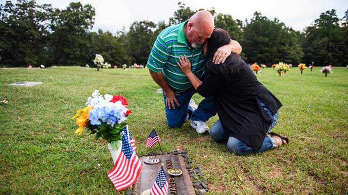 Kevin Johns comforts Kathy Bowling at their son Jared Johns’ grave at Cannon Memorial Park on Thursday, Sept. 27, 2018. Jared Johns, a U.S. Army veteran who suffered from depression due to PTSD, committed suicide on Tuesday, Sept. 11, 2018.
