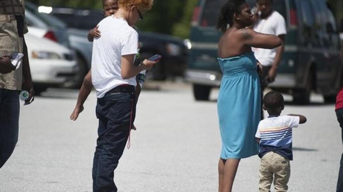 Family members wait outside of Southside High School to pick up students on Friday, May 13, 2016.