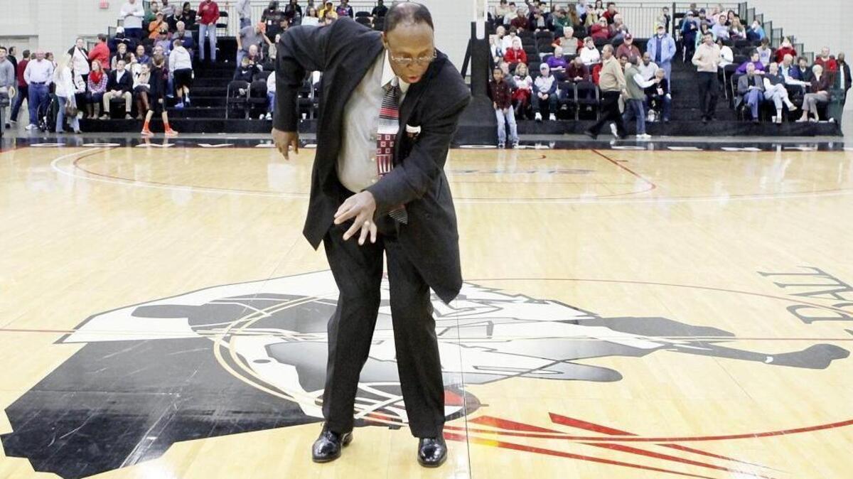 Al Ford, a staple at the Beach Ball Classic and known by nicknames of “Chicken Man,” “Bojangles,” “Big Al” and “Ford,” dances to James Brown music during the 2013 tournament.