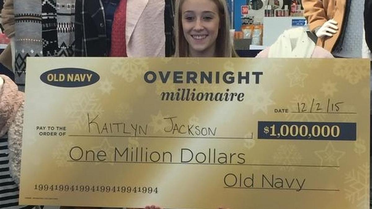 Kaitlyn Jackson, of Piedmont, accepts a $1 million check from Old Navy. She won the store's Overnight Millionaire contest for shopping on Thanksgiving night.