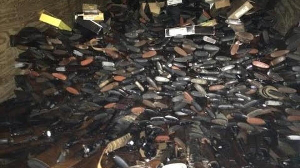 Piles of handguns and rifles found in storage building near home of Brent Nicholson of Pageland.