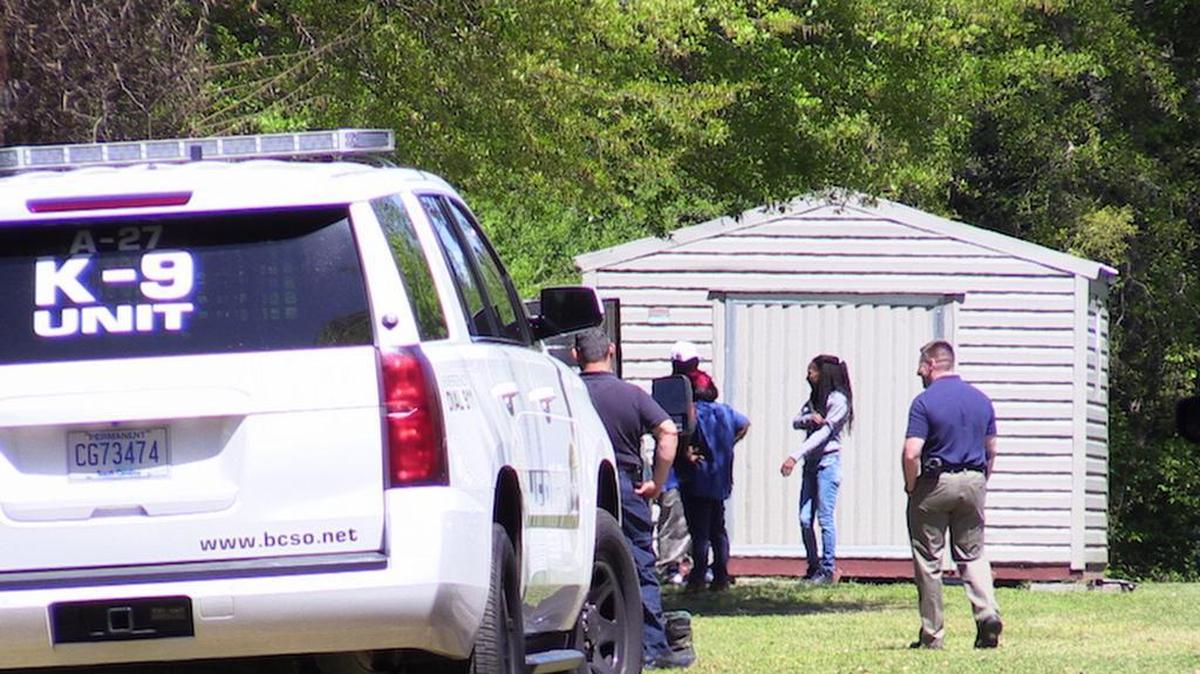 Beaufort County Sheriff Office deputies along with state arson investigators among others are seen at the end of B. Wilson Lane on St. Helena Island on the afternoon of April 8, 2016. Investigators found a body in a shed (not visible) after extinguishing an early morning fire. The body will be sent to the Medical University of South Carolina for a forensic autopsy.