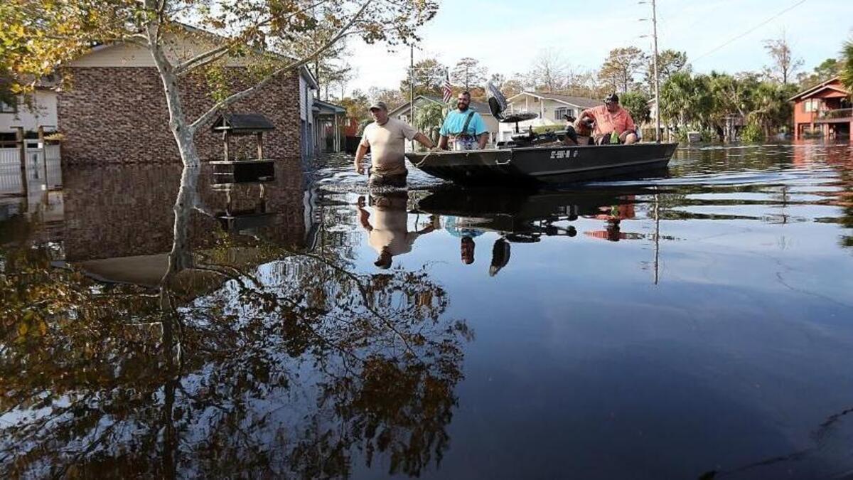 People use boats and friends to help collect pets, food and belongings as they evacuate their homes during the flood in the Rosewood community of Socastee on Saturday, Oct. 15, 2016, one week after Hurricane Matthew hit. A section of the community was under evacuation on Saturday as the water continued to rise. The Waccamaw River feeds into the Intracoastal Waterway south of the community.