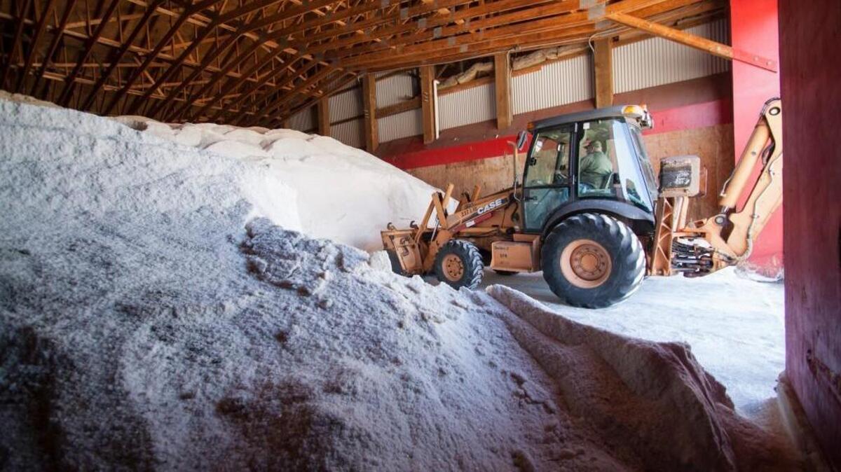 Michael Barrett loosens salt that is mixed with brine at the South Carolina Department of Transportation’s maintenance facility in Rock Hill on Thursday.