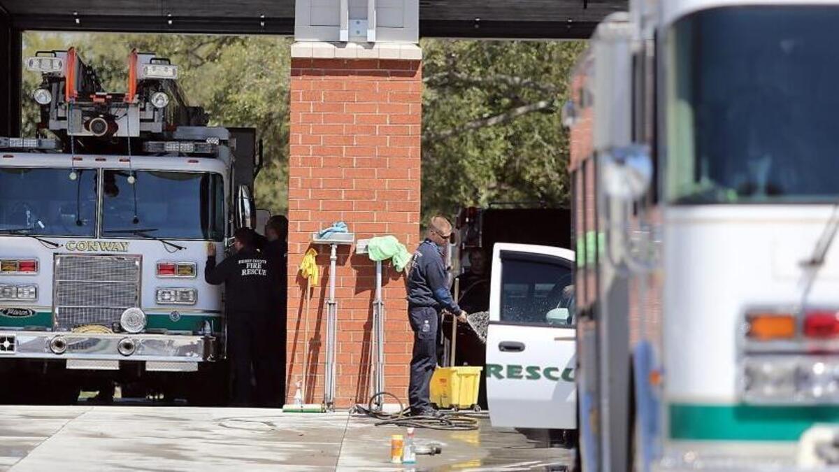 Conway firefighters wash engines as units from Horry County, Myrtle Beach, Surfside Beach, North Myrtle Beach and several other communities cover the city's fire calls on Monday, March 21, 2016. Conway Firefighter Chris Ray died on duty Sunday afternoon while responding to a fire within a half a mile from the fire house.