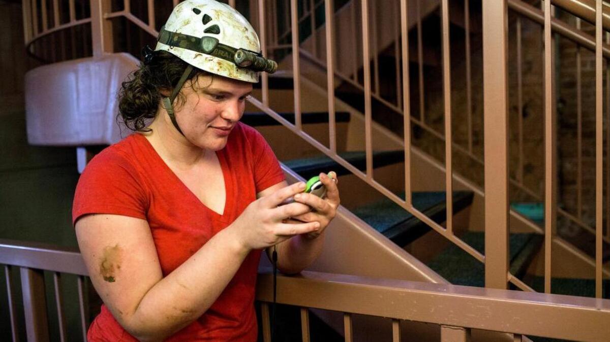 Abby Harmon, 27, of Knoxville, Tenn., checks her phone after being rescued from Hidden River Cave on Thursday, May 26, 2106, after 18 people on a cave tour were trapped due to flash flood waters in Horse Cave, Kentucky.