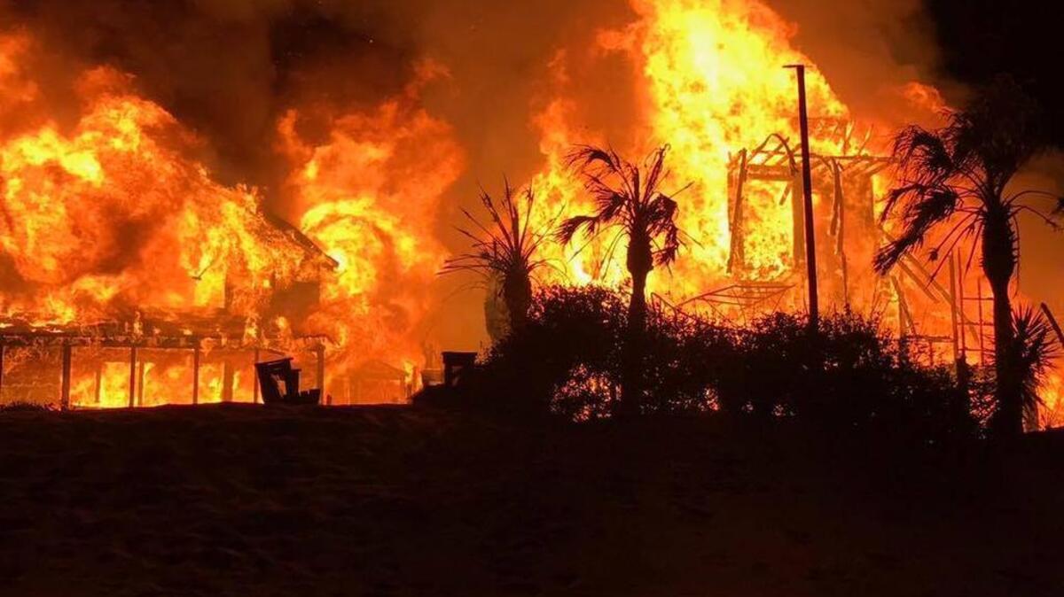 A large fire burns early Wednesday in Pawleys Island. The blaze destroyed two homes.