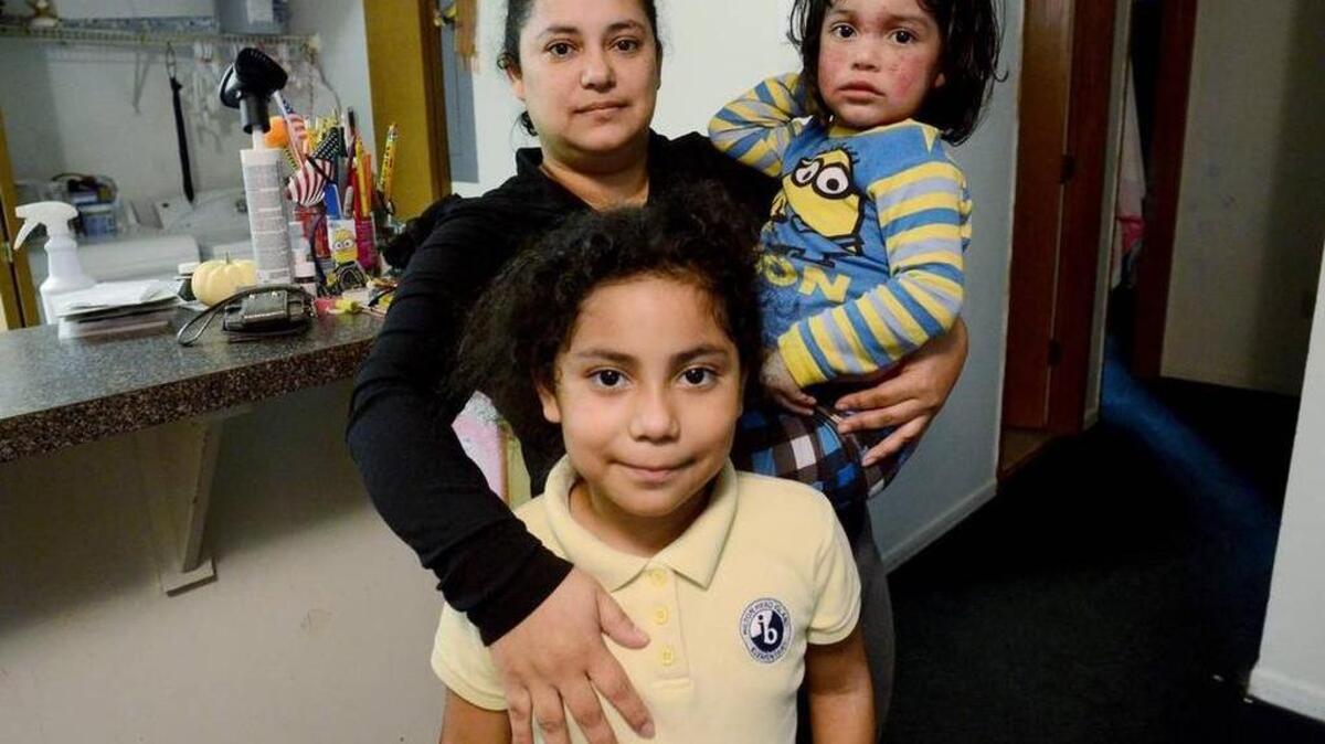 Claudia Toro is photographed with her children, daughter Karhyma Barrientos, 8, and son Marco Brizuela, 2, who suffers from eczema and dry skin, on Friday at their home at 90 Dillon Apartments. The family is one of several at the complex who are about to be evicted.