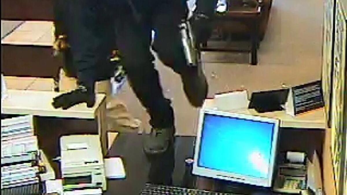 Hooded gunmen are seen walking into the bank with guns in hand, jumping over the bank counter and taking money, then fleeing, in a series of bank surveillance camera images provided by South State Bank and released through the city of North Myrtle Beach.