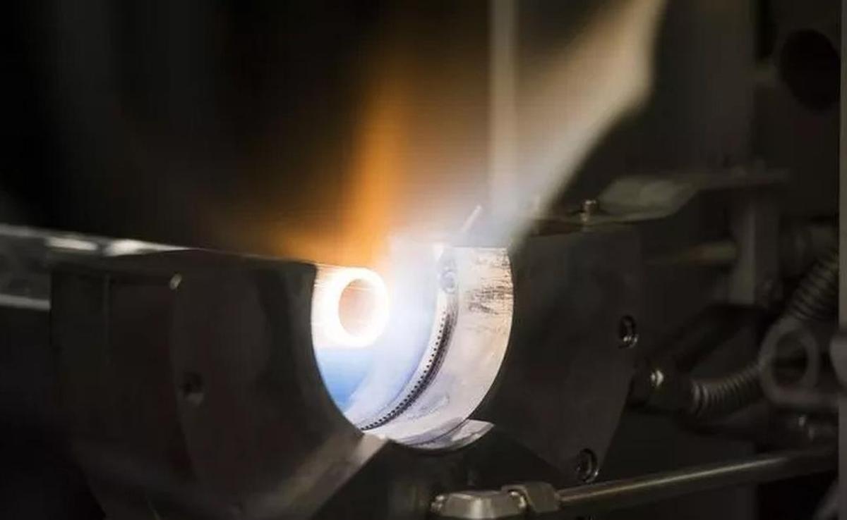 Josh Parsons , a research associate at the Clemson Advanced Materials Research Lab, heats a glass tube before fusing it with another to make fiber optic cables.