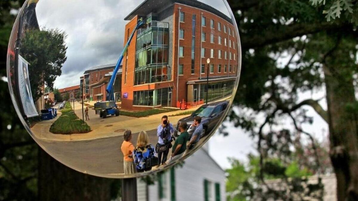Residence Hall A of the Core Campus dormitories, across Fort Hill Street from the Calhoun Mansion, is seen in a mirror set up for cars entering the road. The newly built 260,000-square-foot Core Campus Project houses nearly 700 honors students and freshmen.