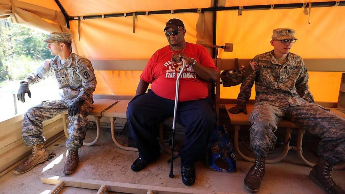 "I've never done this," Glynn Hemingway (center) says as he's evacuated from his home of 10 years in the Bucksport community on Thursday, Oct. 13, 2016. Hemingway said the Horry County Police convinced him to leave saying Cowford Swamp off the Great Pee Dee River is expected to flood with the possibility of a dam being breached upstream in Florence County.