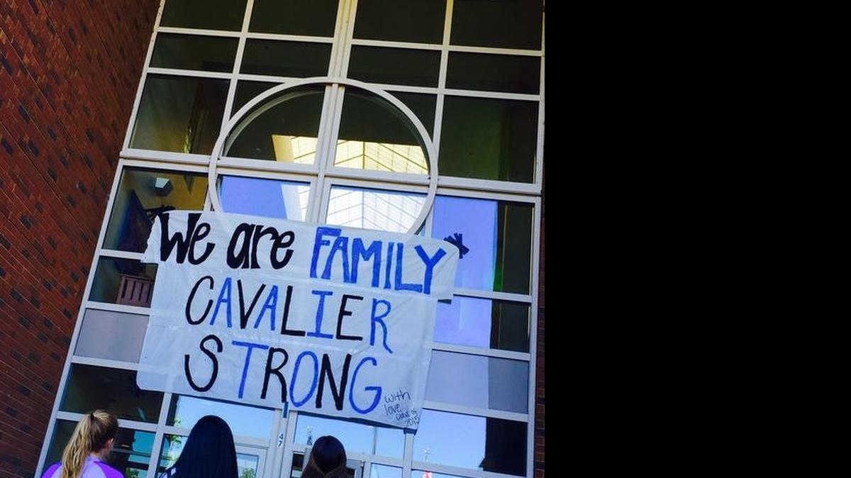 
Christ Church Episcopal School seniors look at a banner they hung above the school entrance in response to a racist photo created by a student.
