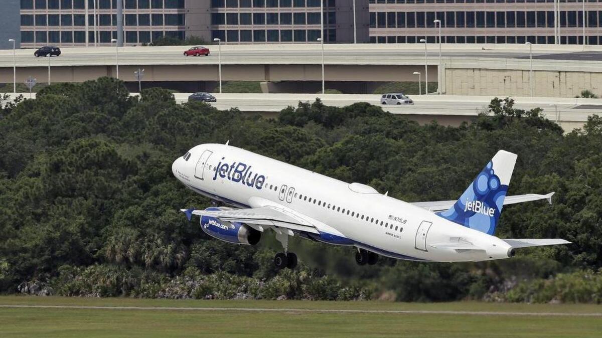FILE - In this Thursday, May 15, 2014, file photo, a JetBlue Airways Airbus A320-232 takes off from the Tampa International Airport in Tampa, Fla.