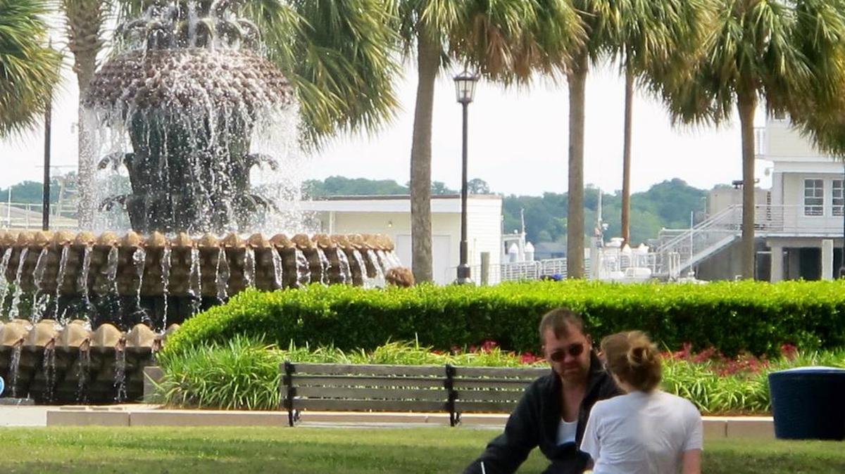 File photo. A couple chats near the Pineapple Fountain in the Waterfront Park in Charleston, S.C.