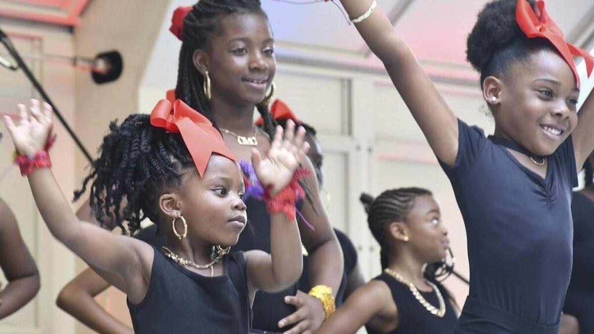 Thousands of people gather on Main Street for Columbia’s Main Street Latin Festival on Aug. 26, 2017. The festival includes Latin dancing, music, arts, and the best Latin food you can find in Columbia. Here, Kendyll Rufus (4), left, Jordan Thompson (10), center, and Madison Boyd (6), right, perform with the Charismatic Dance Studio on the main stage for the crowd. The dance company is based in Northeast Columbia.